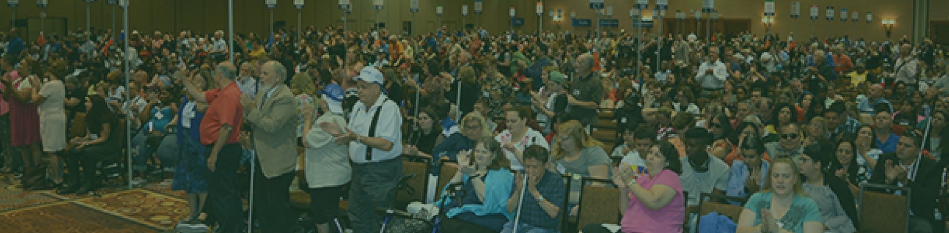 Large group of convention attendees clapping