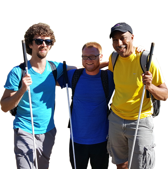 Three men holding their white canes smiling and posing for a photo.